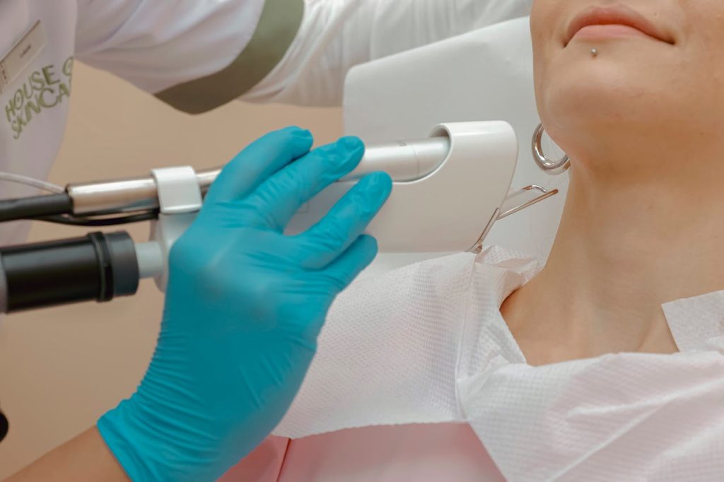 Close-up of a woman receiving a laser skin treatment in a clinic.